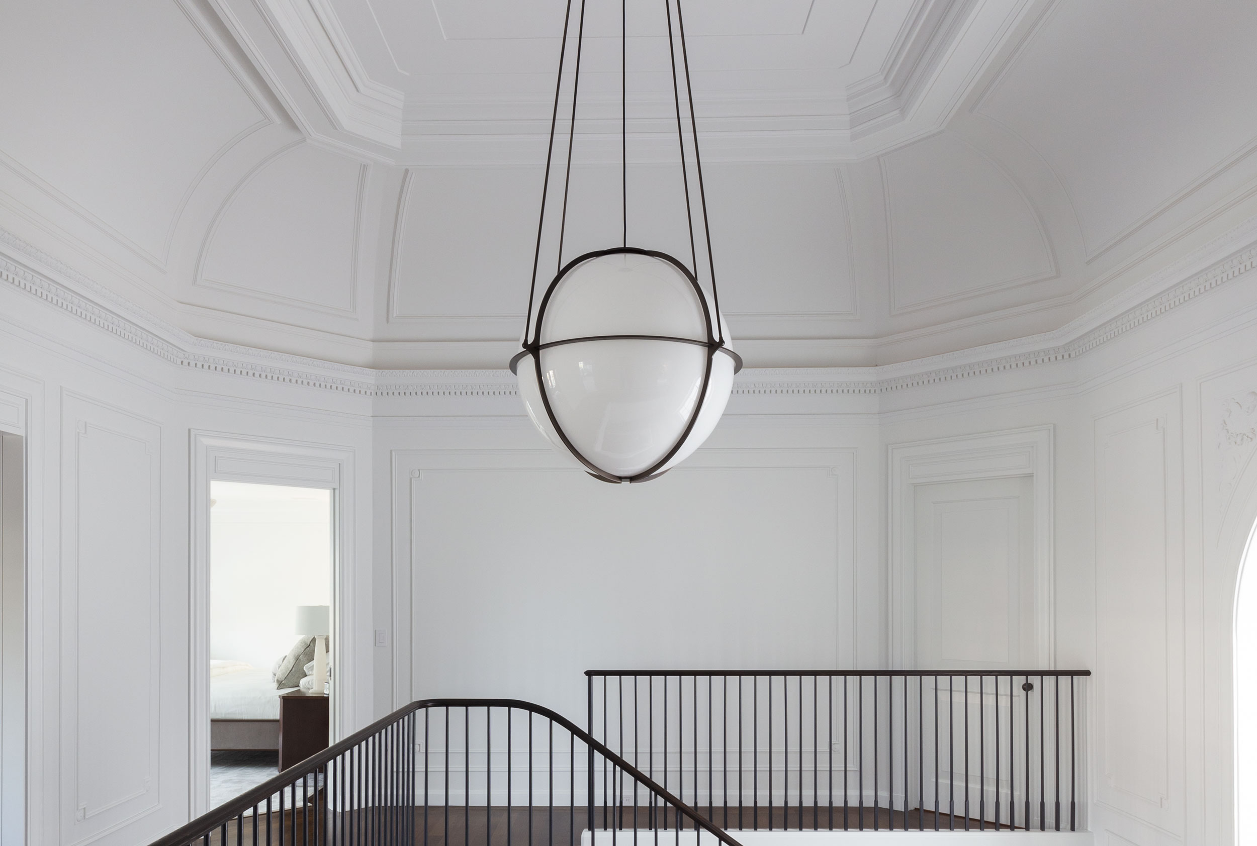 Boyd Lighting's Globe Pendant here in 35" diameter visually lowers the ceiling in a large volume space